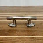 Polished stainless boat cleat with tear-drop base, front view