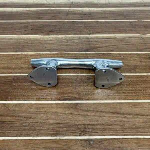 Angled view of a polished stainless boat cleat with tear-drop base