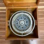 vintage ship compass top view inside fitted wooden case