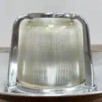 Close-up of aluminum cage and ribbed globe on ceiling light