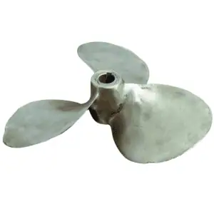 Isolated image of a brass 12 inch propeller with signs of wear and a polished surface
