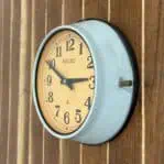 Side angle 1: Side angle of Seiko nautical wall clock showing dent and metal frame