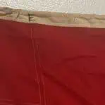 Close-up of the edge of a Letter E nautical flag showing stitched label