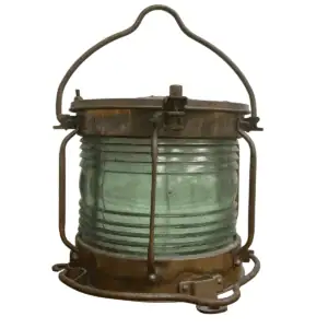 Front view of salvaged brass ship lantern with green Fresnel glass and heavy patina