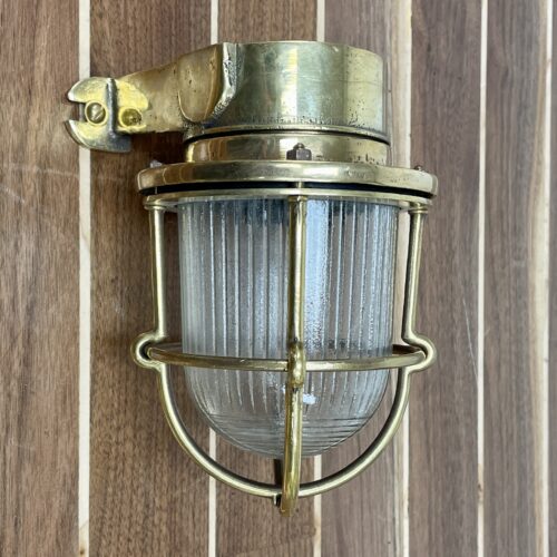 Small Brass Wall Sconce With Decorative Concentric Circle Globe