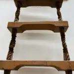 Wood ladder detail showing worn steps and rope construction