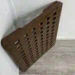 Side view of a nautical wooden grate with risers, highlighting its rectangular shape.