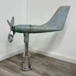 Another side angle of the salvaged ship anemometer, showing the propeller, vane, and worn paint details.