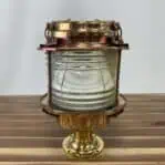 Side view of ship-salvaged brass pier light showing durable construction and clear lens.