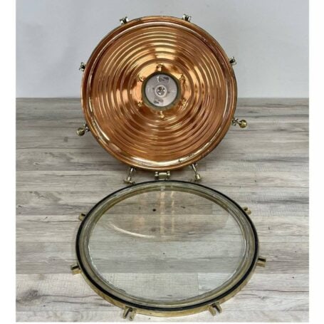 Inside view of large brass pendant light, highlighting internal structure and polished brass