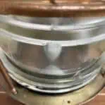 Close-up of chipped Fresnel lens on brass nautical post light
