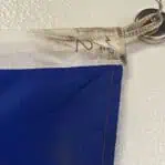 Edge detail of the International Code of Signals numeral 2 flag showing handwritten “No 2” marking and rope attachment.