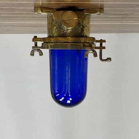 Nautical Ceiling Light With Blue Glass 01 Nautical ceiling light with blue glass and brass finish, front view