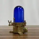 Standard view of nautical ceiling light with blue glass and brass detailing