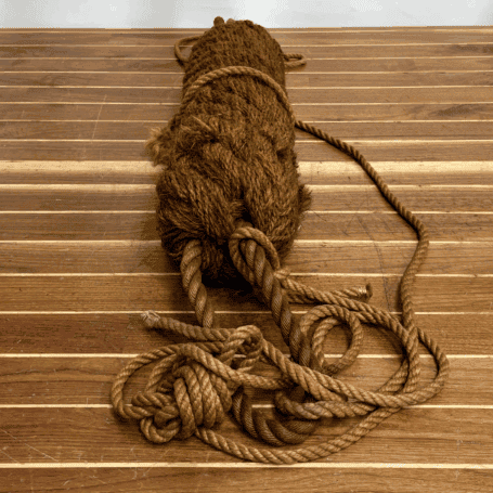 Vintage Natural Rope Boat Bumper (5) Hand-tied rope bumper laid flat on wood surface with long rope lines