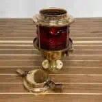 Front view of salvaged pier light with top removed, showing red glass lens