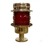 Salvaged pier light with red glass lens on white background