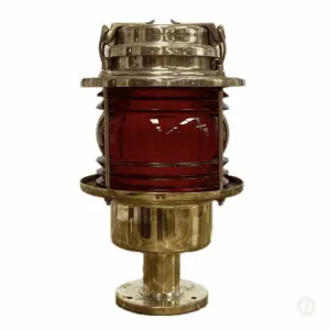 Salvaged pier light with red glass lens on white background