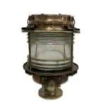 Brass pier light with flat-sided housing and 360-degree clear Fresnel lens on a white background