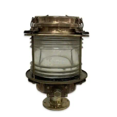 Brass pier light with flat-sided housing and 360-degree clear Fresnel lens on a white background