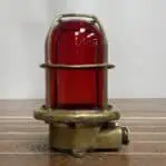 Mounted vintage brass red glass globe ceiling light showing brass cage and red glass