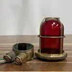 Disassembled brass cage and red globe from nautical ceiling light fixture
