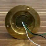 Wiring detail on the base of a brass ceiling cage light