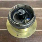Close-up of socket inside brass ceiling cage light housing