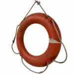 Side angle of salvaged weathered orange life ring showing reflector tape and wear
