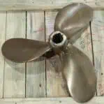 Front view of salvaged 16-inch bronze propeller showing patina and wear