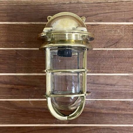 Front view of vintage brass wall sconce, highlighting the solid brass construction and nautical design