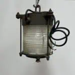 Rust-textured steel top and brass body of lantern