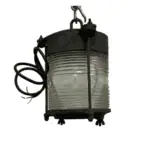Side profile of weathered brass and steel lantern