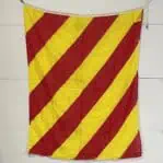 red and yellow striped nautical signal flag hanging on wall