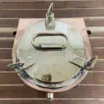 Copper and brass running light top view showing brass lid and wingnuts