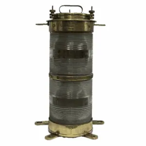 Front view of vintage marine navigation light with double-stacked Fresnel lens in brass by Forcato-Verona on white background