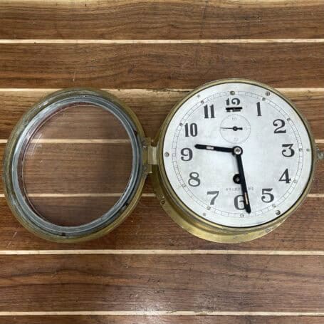 Vintage Brass Nautical Ship Clock - Mechanical Wind-Up Open-face view of vintage brass nautical clock showing mechanical dial and hinged glass cover.