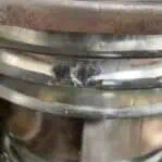 Close-up of chipped glass on vintage galvanized 225 degree running light lens