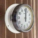 Side Angle: Alternate side view of Vintage HANIL Ship Clock highlighting wear on steel case