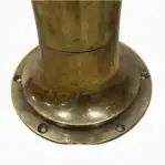 Base of vintage engine telegraph showing brass mounting flange