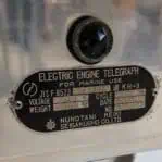 Close-up of name plate on electric engine telegraph, displaying Nunotani Keiki Seisakusho branding