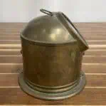 Side profile of vintage Sestrel compass showing patina on brass housing