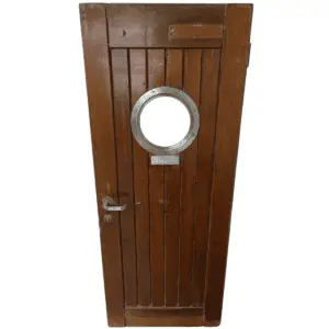 Front view of a salvaged ship's door with a metal-framed porthole window and two-tone wood finish