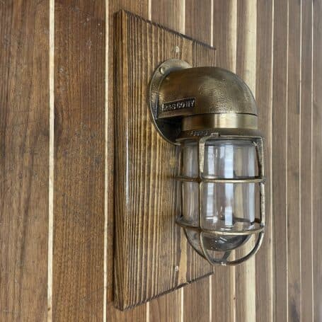 Vintage Brass Nautical Wall-Mounted Light On Wood Base 02 the Vintage Brass Nautical Wall-Mounted Light On Wood Base on a wall