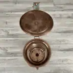 Lid open showing interior of copper housing