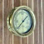 Side view of an Antique American Bourdon Gauge, showing solid brass construction and vintage design from the early 1900s.