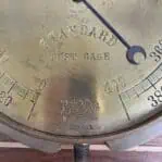 the company name and logo on the brass gauge