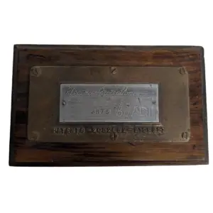 Front view of vintage ADT brass and aluminum plaque on wood mount in good condition