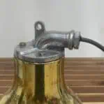 Top view of the wiring conduit on a restored marine light fixture.