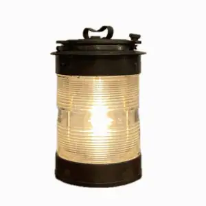 Lit salvaged brass nautical light with clear Fresnel lens